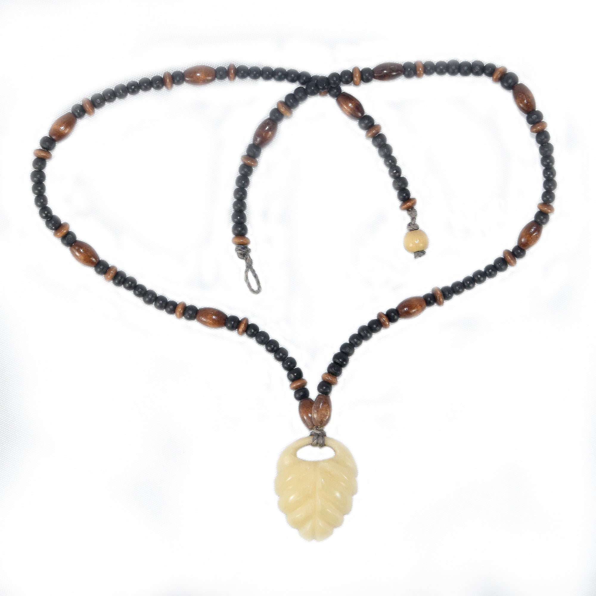 Carved tagua palm nut pendant and wooden bead necklace - made by an artisan from the Peruvian Amazon - Amazon Ecology