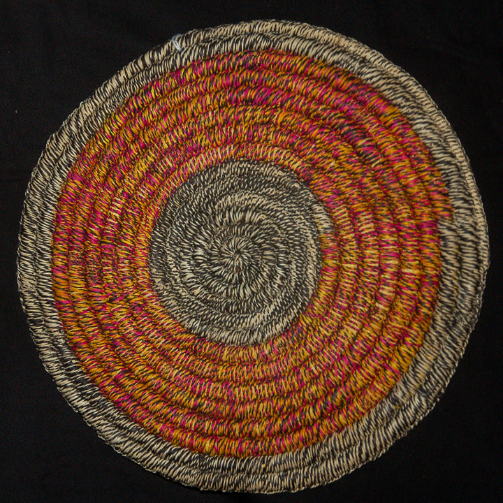 Woven hot pad (trivet) and center piece with blended pink and yellow rings - Amazon Ecology